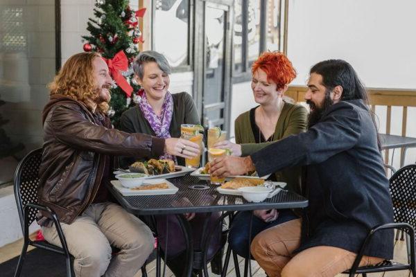 friends enjoying a meal outdoors during winter