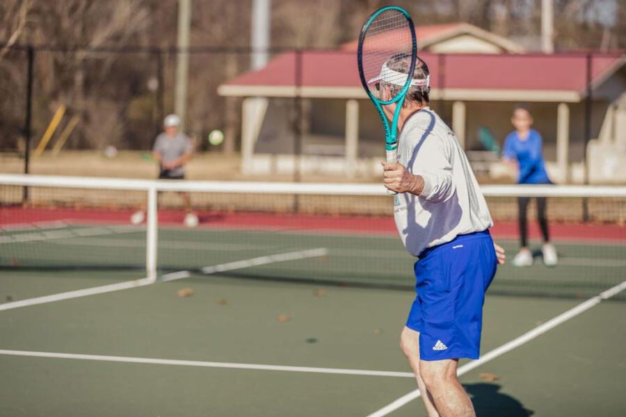 A man swinging a tennis racket