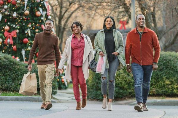 friends walking outside with Christmas decorations